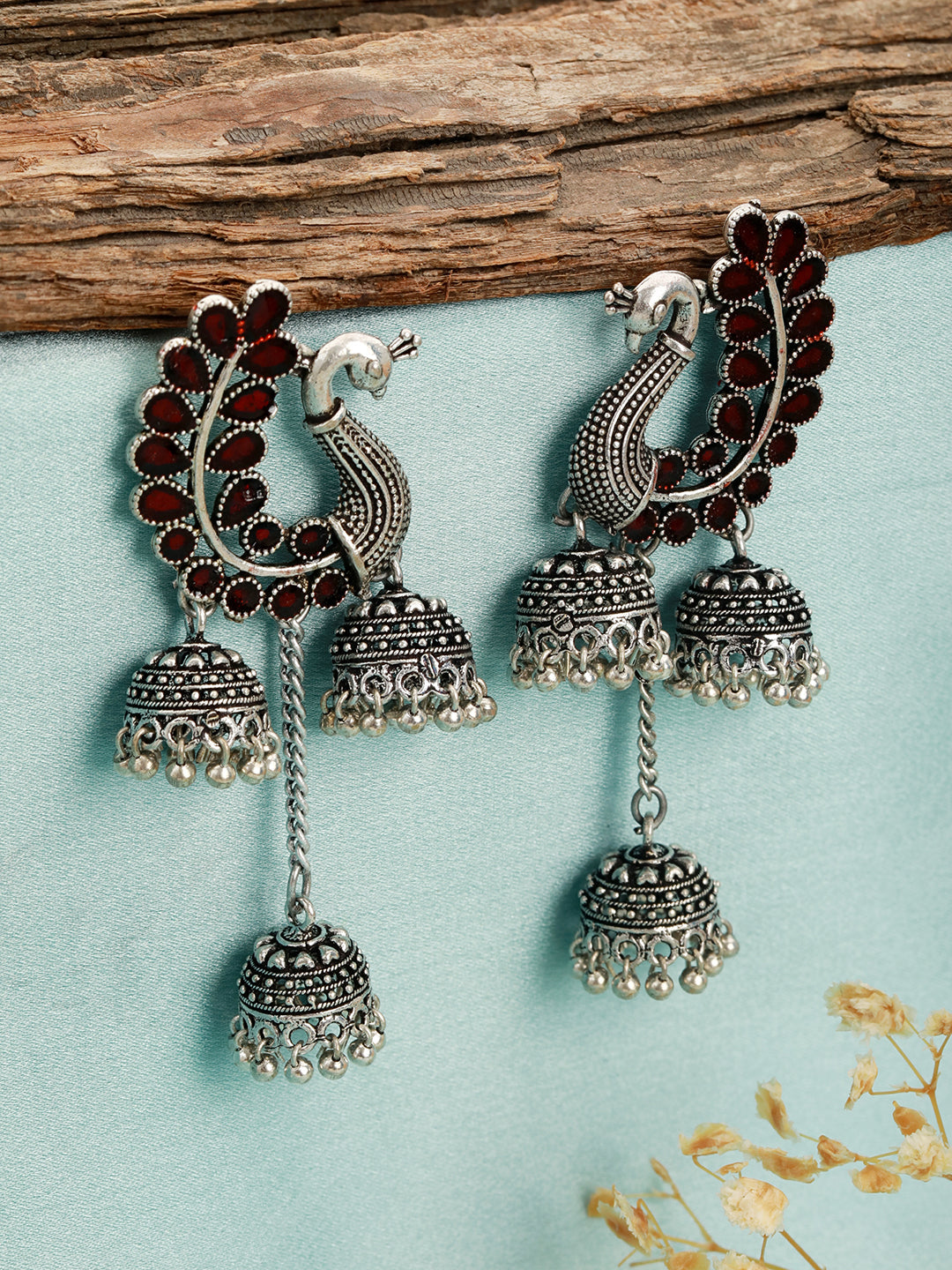 Silver-Plated Maroon Stone Studded Handcrafted Peacock Shaped Jhumkas Earrings