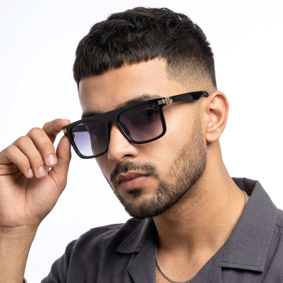 Eyejack Shine Black Rectangle Sunglasses for Men and Women - worn by a male model (image 1)