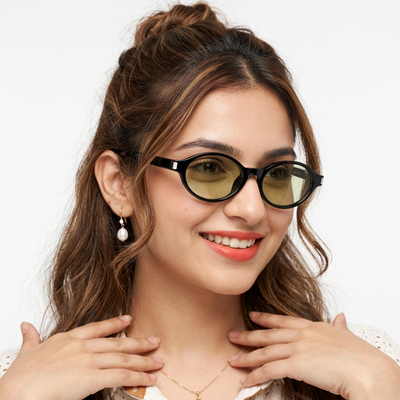 Bloom Black Oval Sunglasses for Men and Women - Style 2186 - worn by a male model (image 1)