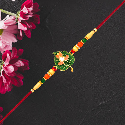 Green Tulsi Leaf Rakhi With Orange Enamel Flower And Beaded Thread
