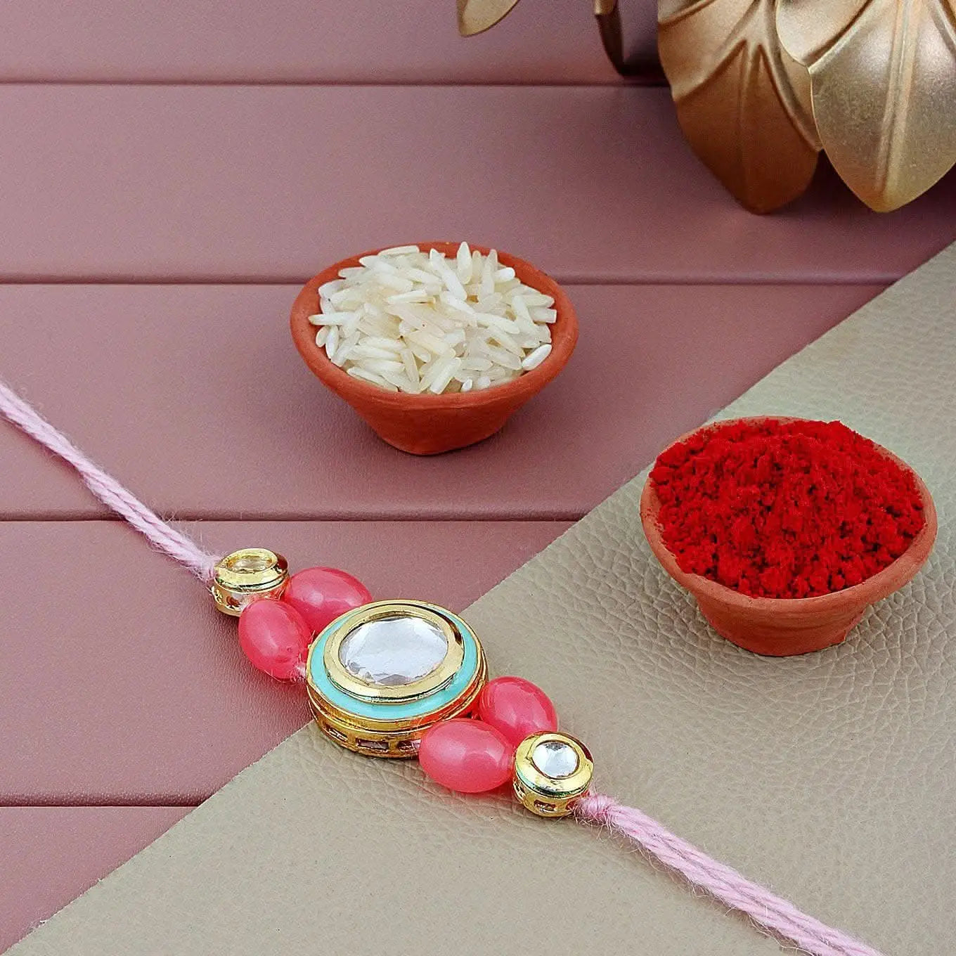 Designer Gold-Plated ferozi color meena thread rakhi with pink thread | LUCKY JEWELLERY - halfpeapp